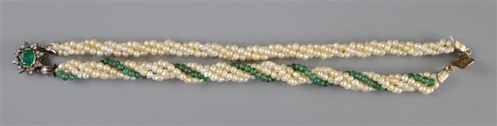 An early 20th century interwoven seed pearl and emerald bead bracelet, with foil backed emerald and diamond cluster set gold clasp,